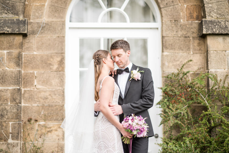 Bride and groom by building